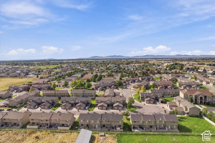 Expansive neighborhood with diverse residential structures and distant mountains