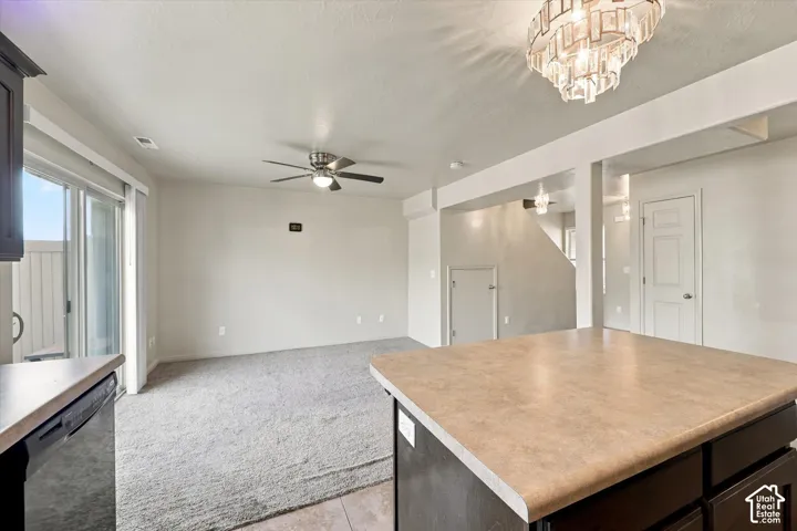 Kitchen island with a laminate countertop and dark wood-finish cabinetry