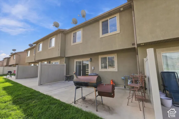 Concrete patio with privacy fencing and a sliding glass door