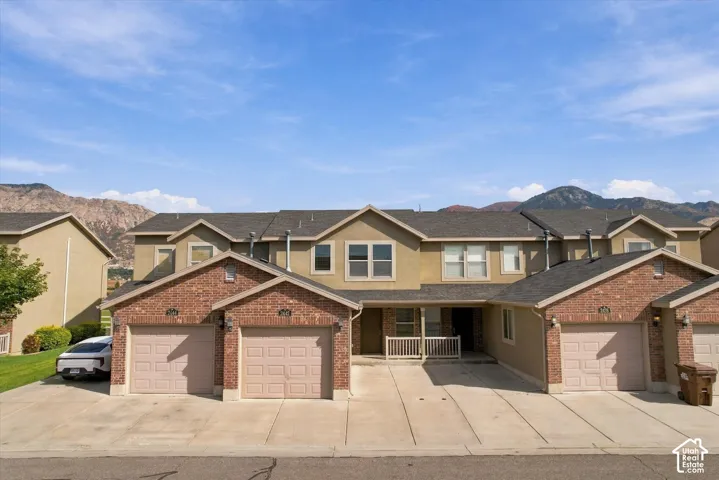 Townhome exterior featuring brick and stucco siding