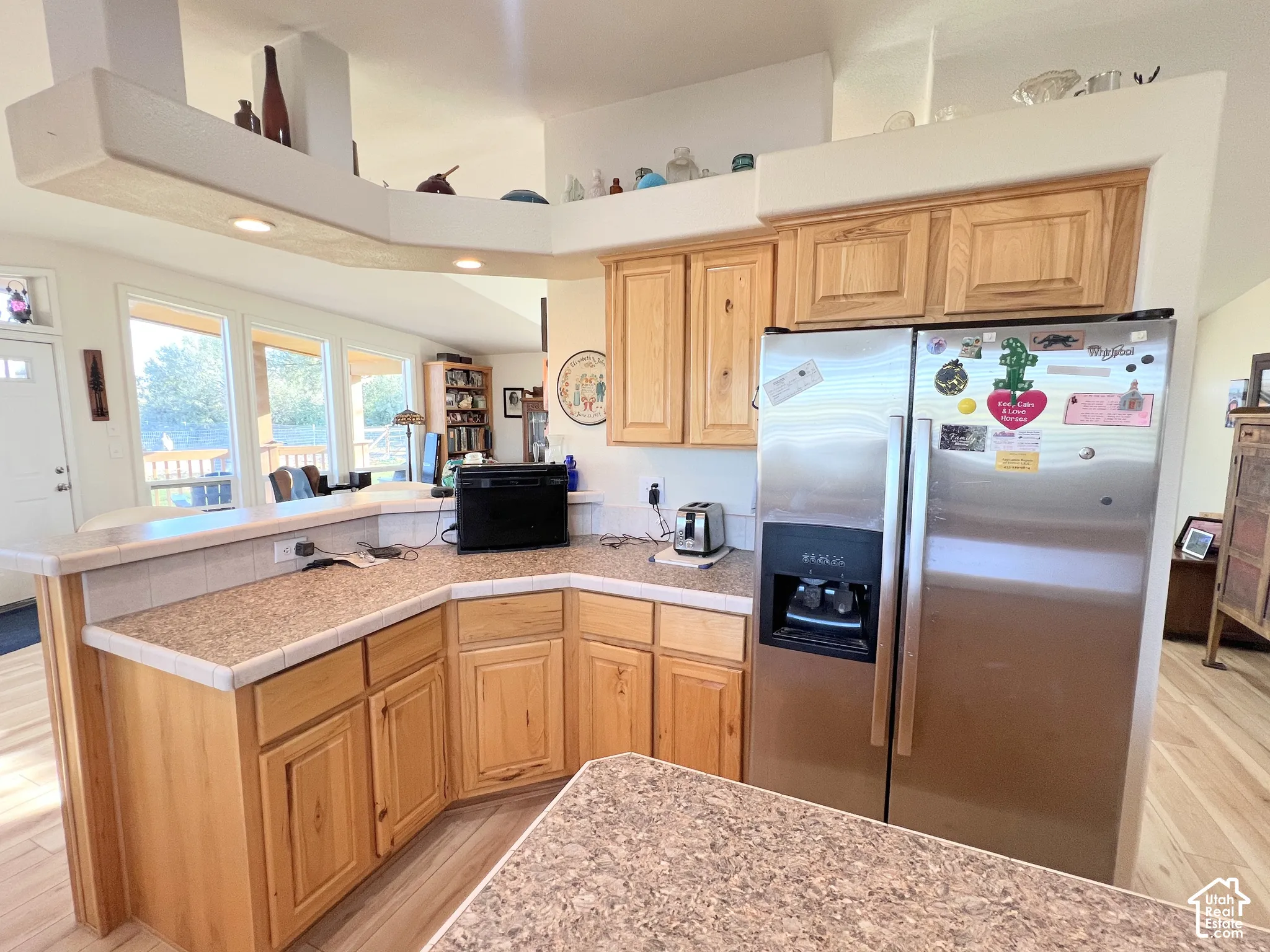 Wood-finish cabinetry paired with granite-style countertops and a tile backsplash