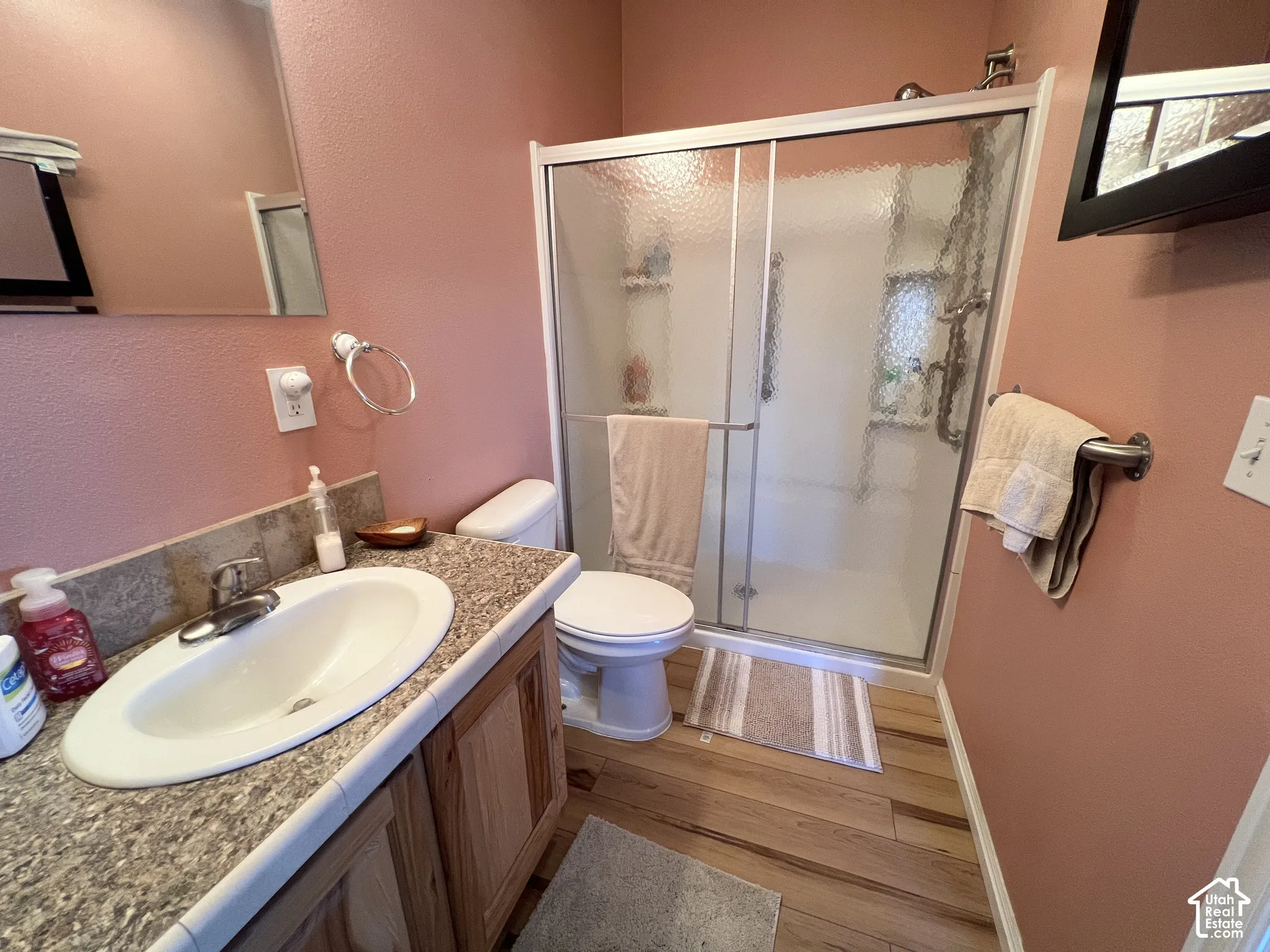 Vanity with an integrated sink, granite-look countertop, and wood-finish cabinetry