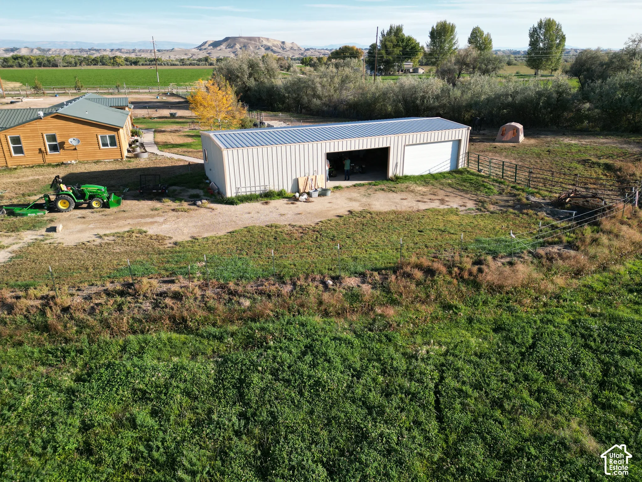Wood-sided residence with a metal roof and an expansive metal utility building