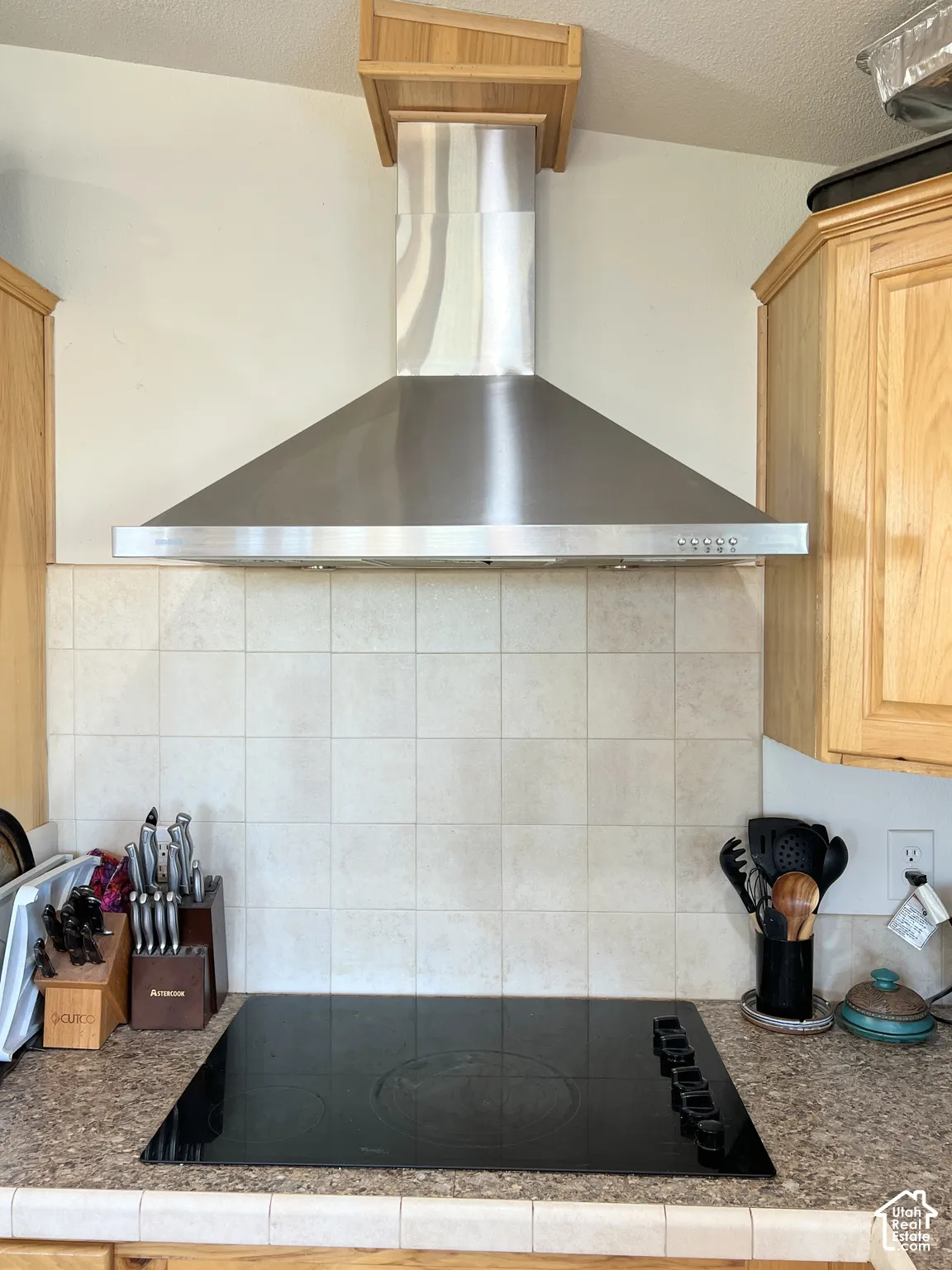 Stainless steel range hood with a wood-finish enclosure