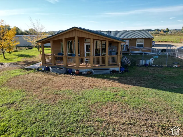 Wood-sided exterior featuring an elevated covered porch with wood railings and a metal roof