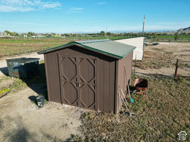 Brown storage shed with a green metal roof