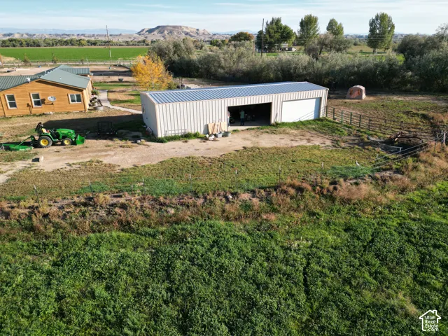 Wood-sided residence with a metal roof and an expansive metal utility building