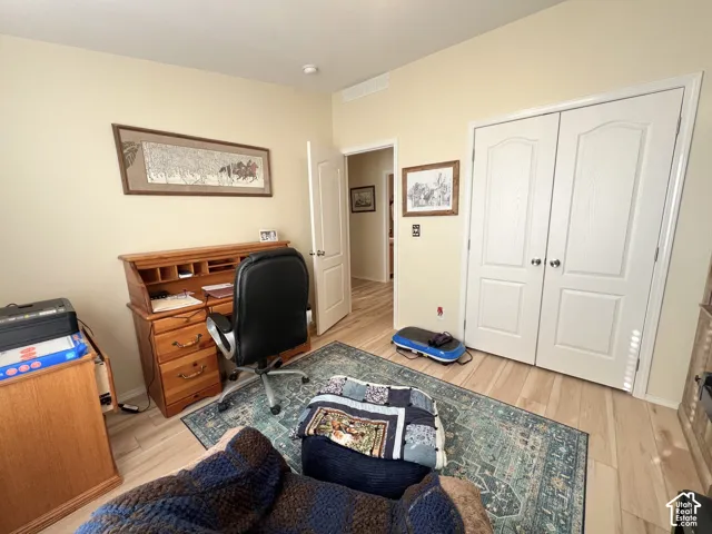 Light wood-finish flooring complements the neutral wall color