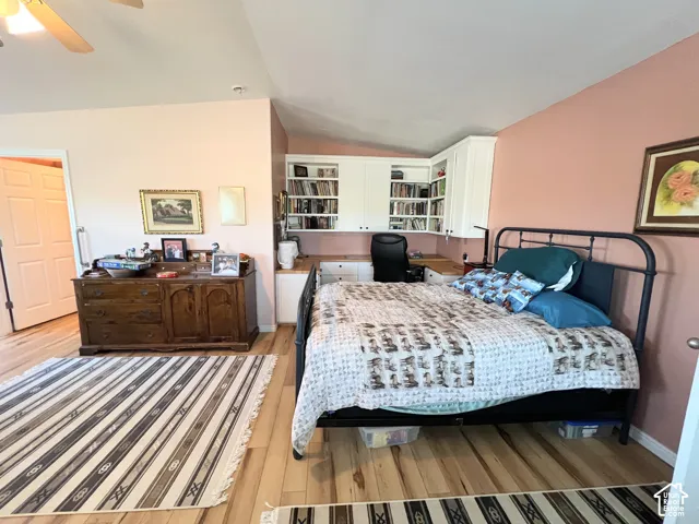 Wood-finish flooring, built-in desk, built-in shelving, vaulted ceiling, ceiling fan