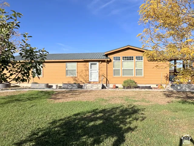 Siding exterior with a metal roof and multiple windows