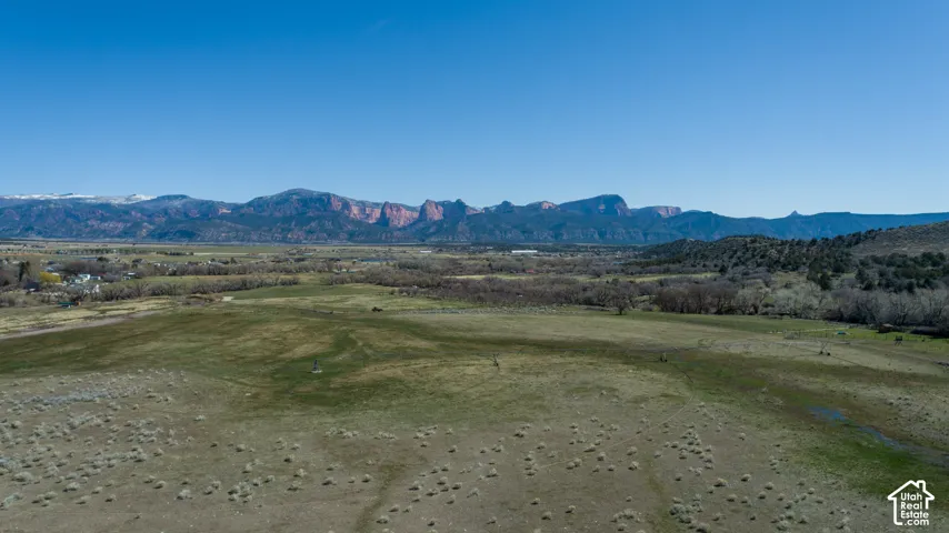 Expansive open land with a distant mountain range backdrop