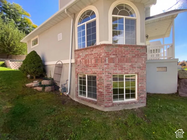 Stucco exterior with a brick accent foundation