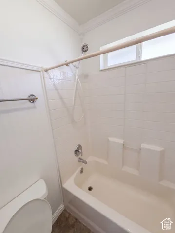 Tub and shower combination with chrome fixtures and white tiled surround