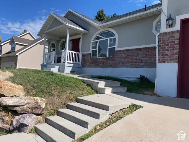 Stucco and brick exterior with a covered porch