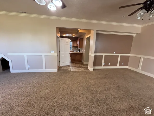 Crown molding accents spacious living area with board and batten wall detailing