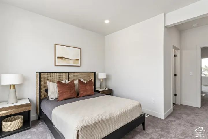 Recessed lighting, light gray wall paint, dark wood-finish flooring, and a textured carpeted area Pictures are of the model home