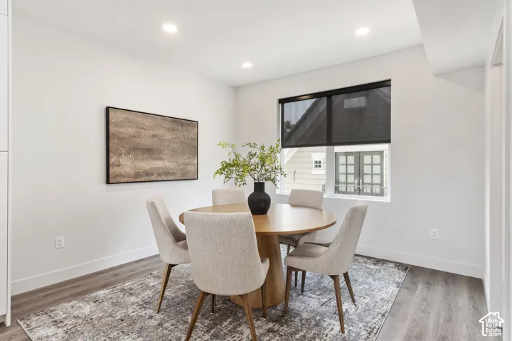 Recessed ceiling lighting, wood-finish flooring, and a window with a roller shades Pictures are of the model home