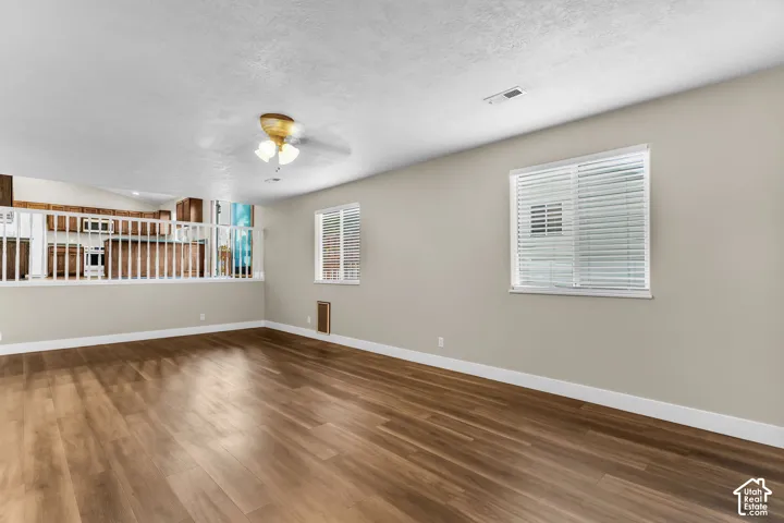 LVP flooring throughout, light-colored wall paint, white window blinds, and white interior railing