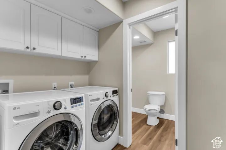 White shaker-style cabinetry with chrome hardware, recessed lighting, and wood-finish flooring