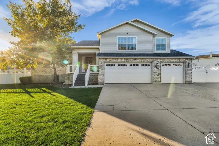 Two-story multi level, exterior with light toned siding and brick accents, nice covered front porch facing North