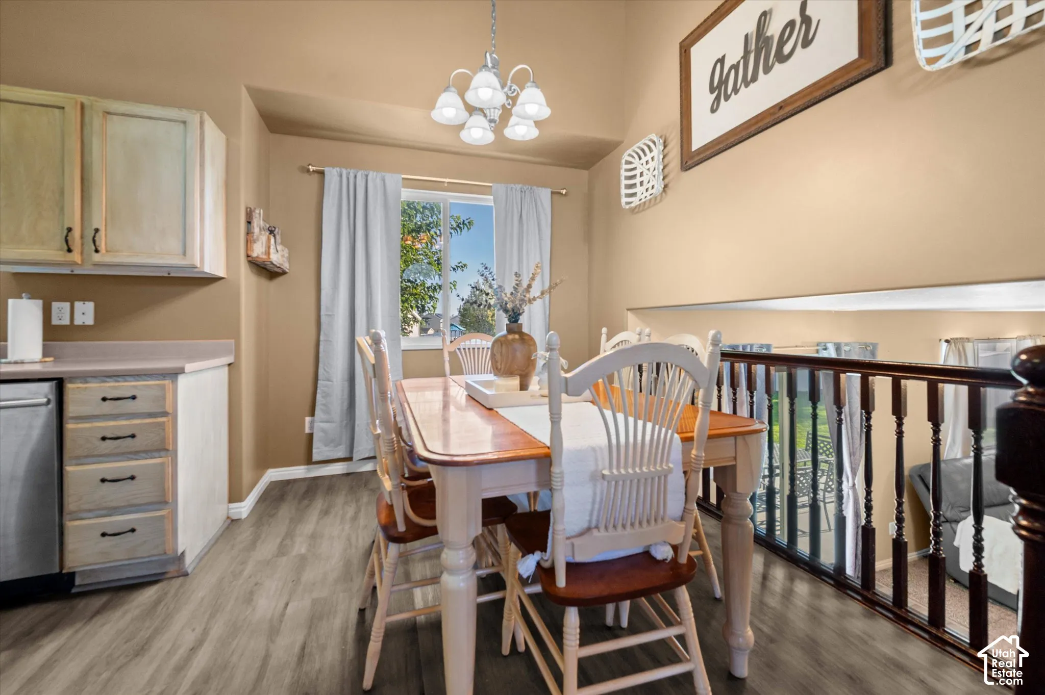 Wood-finish flooring, recessed lighting, and a dark wood railing