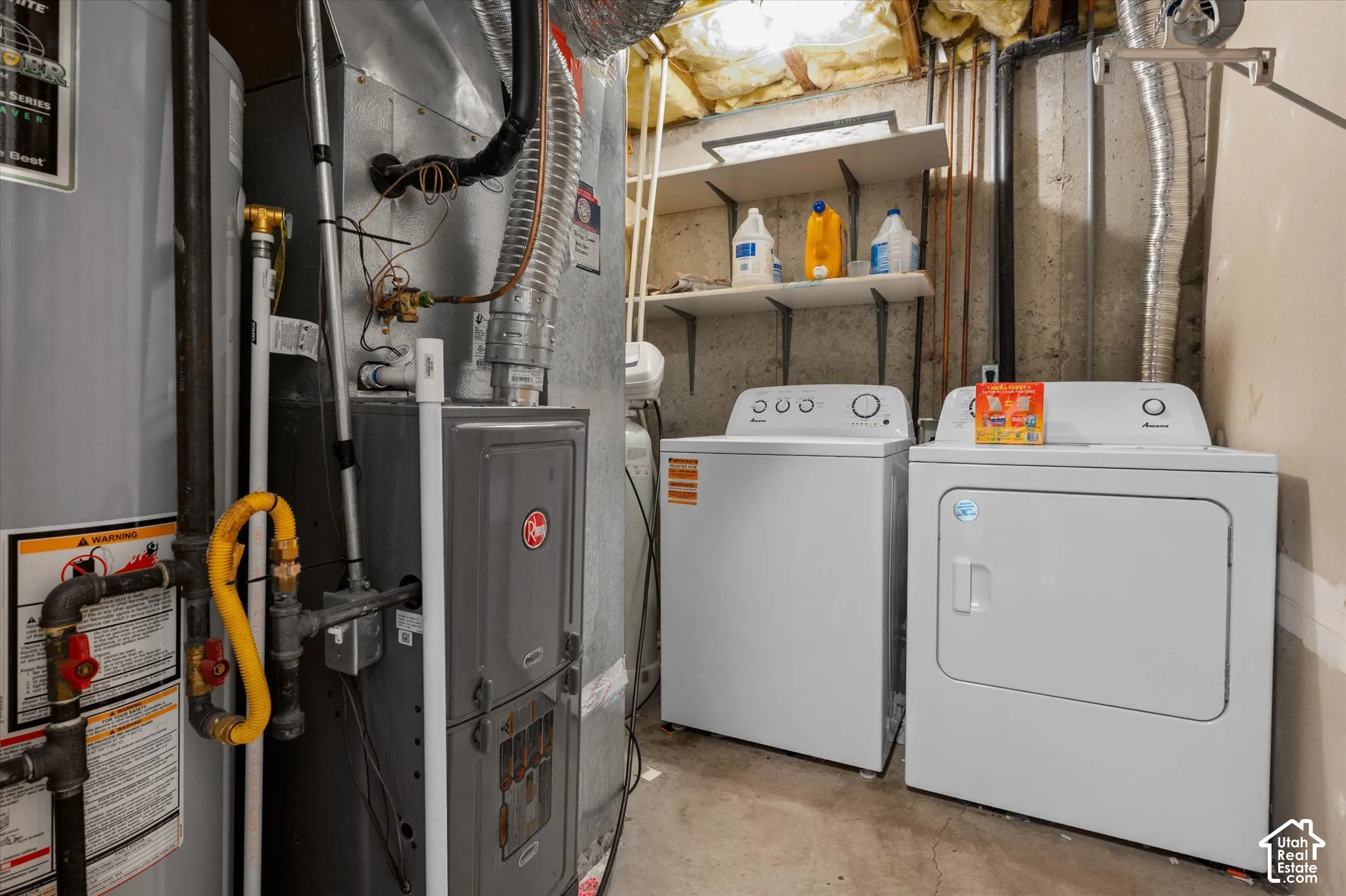 Laundry area featuring a washer and dryer, a water heater, and a furnace