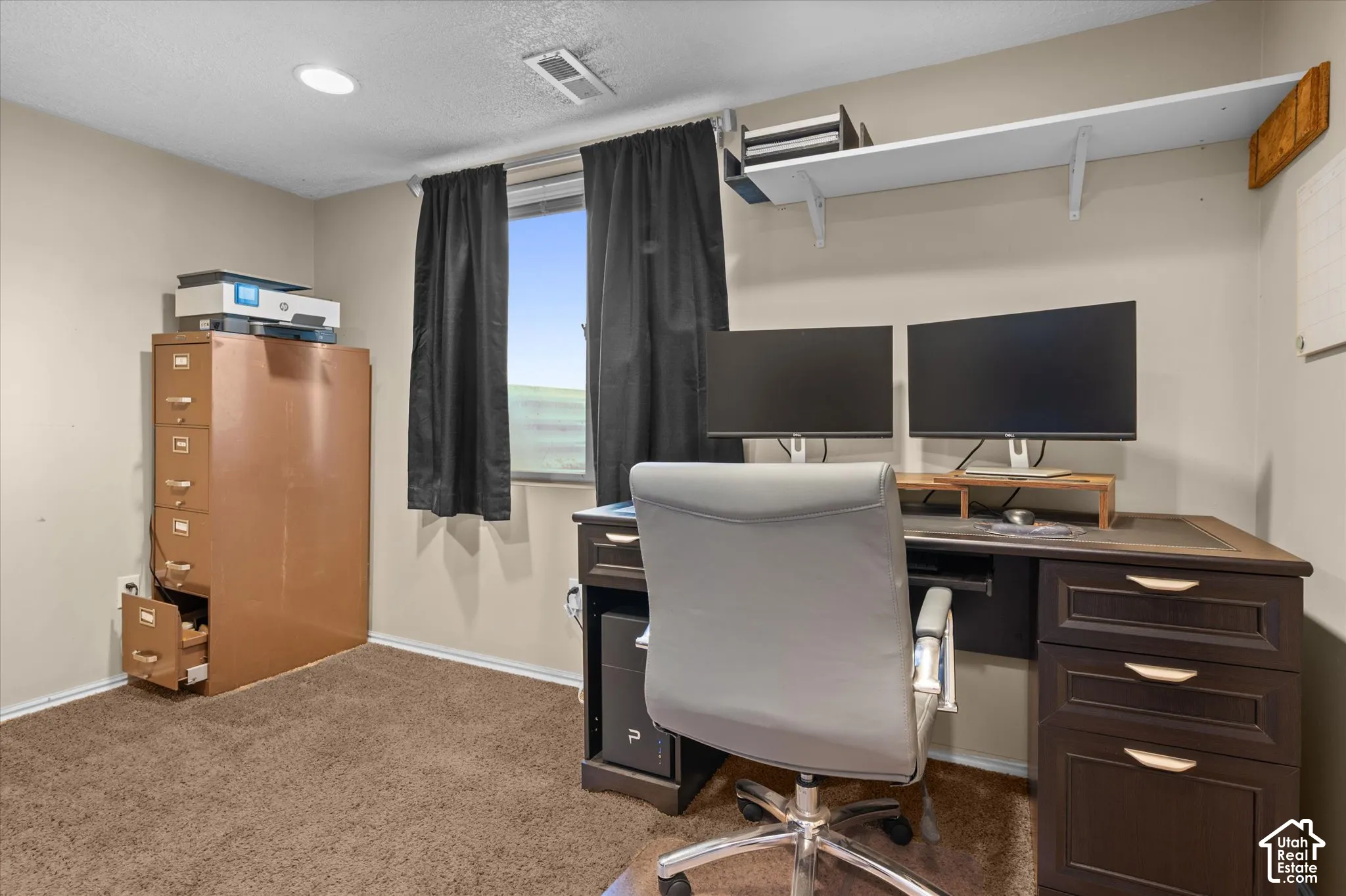 Recessed lighting, window with black drapery, wall-mounted shelving, and carpeted flooring