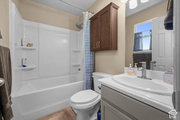 Built-in tub and shower combination with integrated shelving, a single vanity with an oval basin, and a wall-mounted wood-finish cabinet