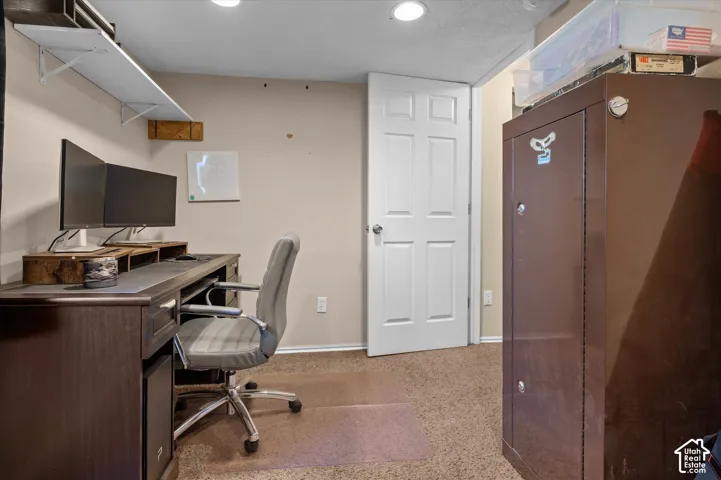Wall-to-wall carpeting with light-colored walls and a paneled interior door