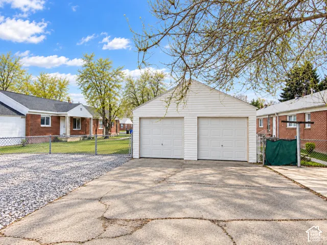 Detached two-car garage with white vinyl siding