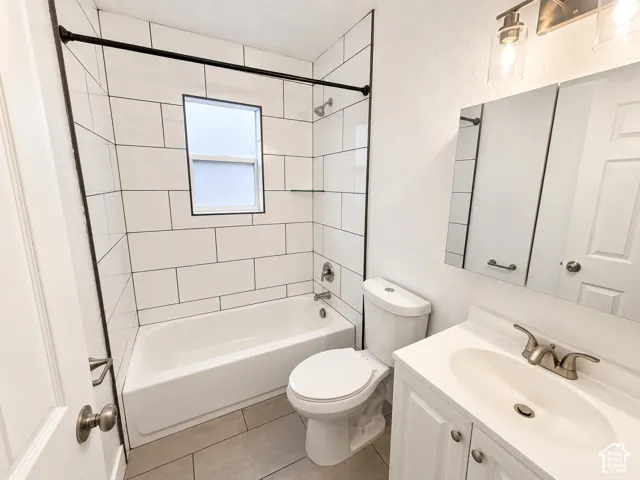 Tub and shower combination with white subway tile surround, single window, and black shower rod