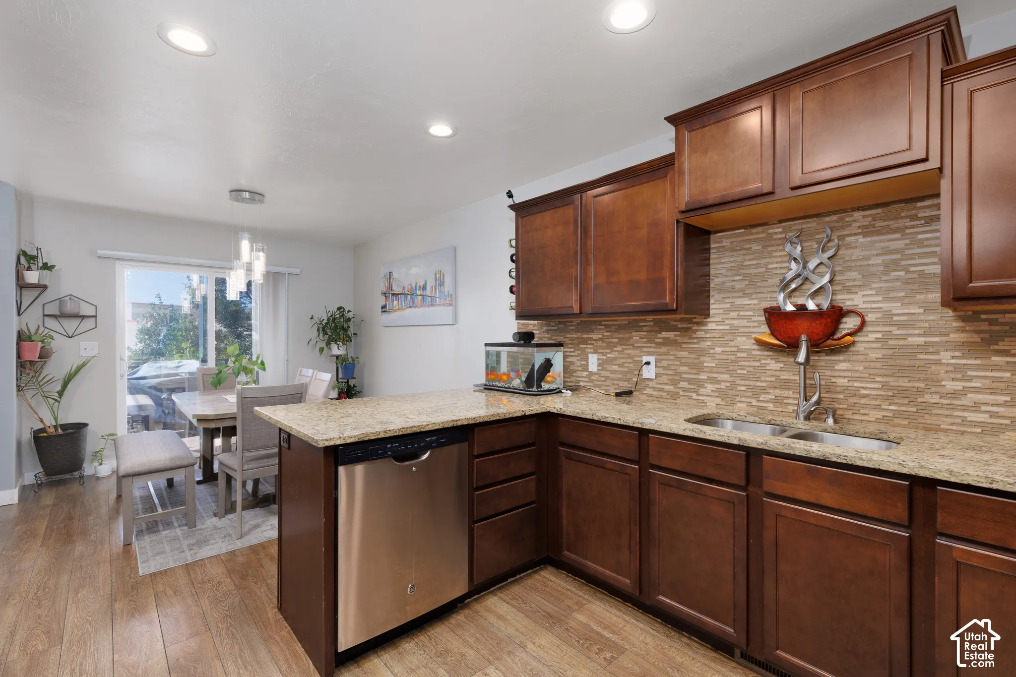Kitchen featuring wood-finish flooring, dark wood cabinetry, and light-toned countertop