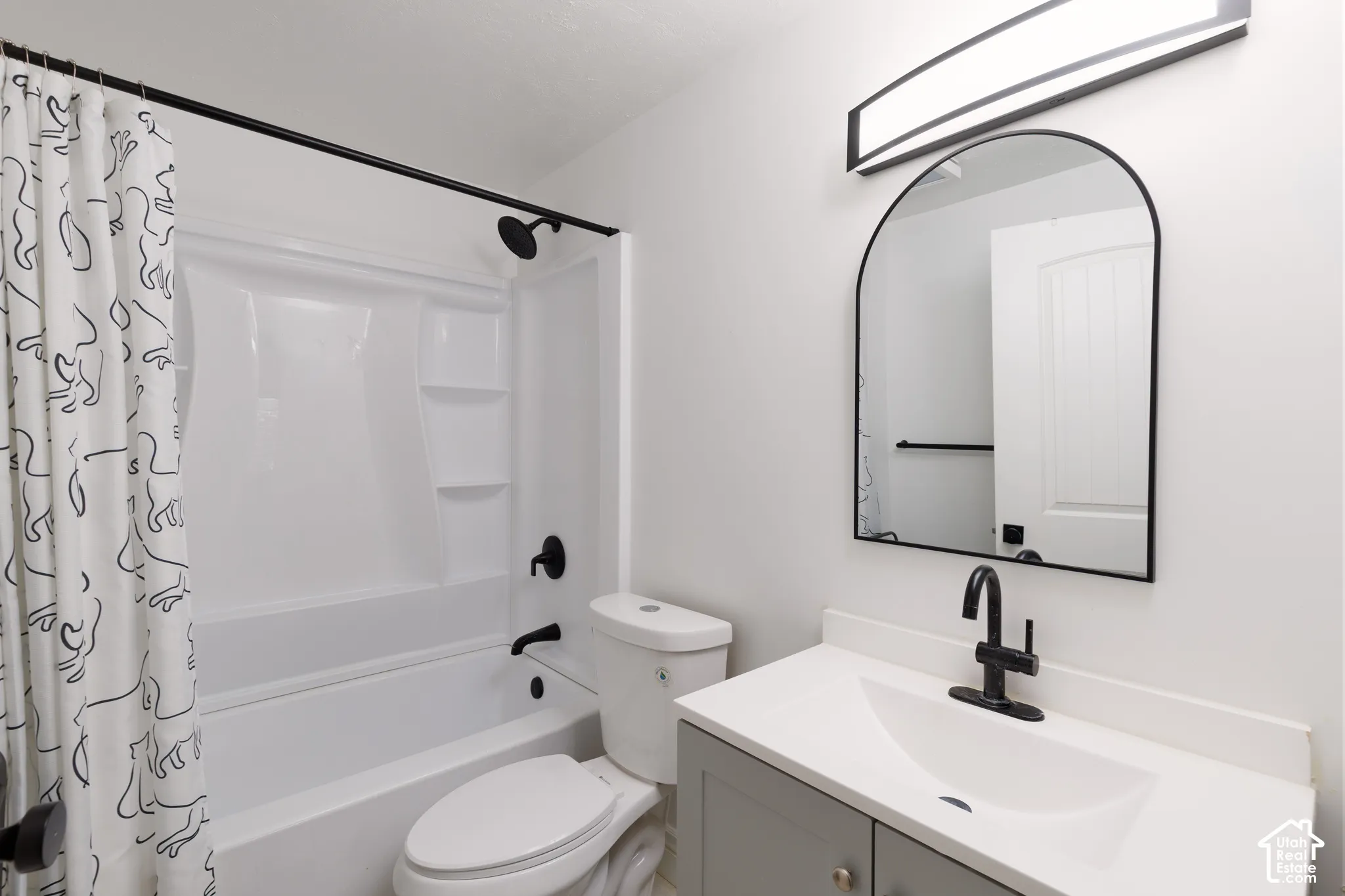 White shower and tub combination with matte black fixtures