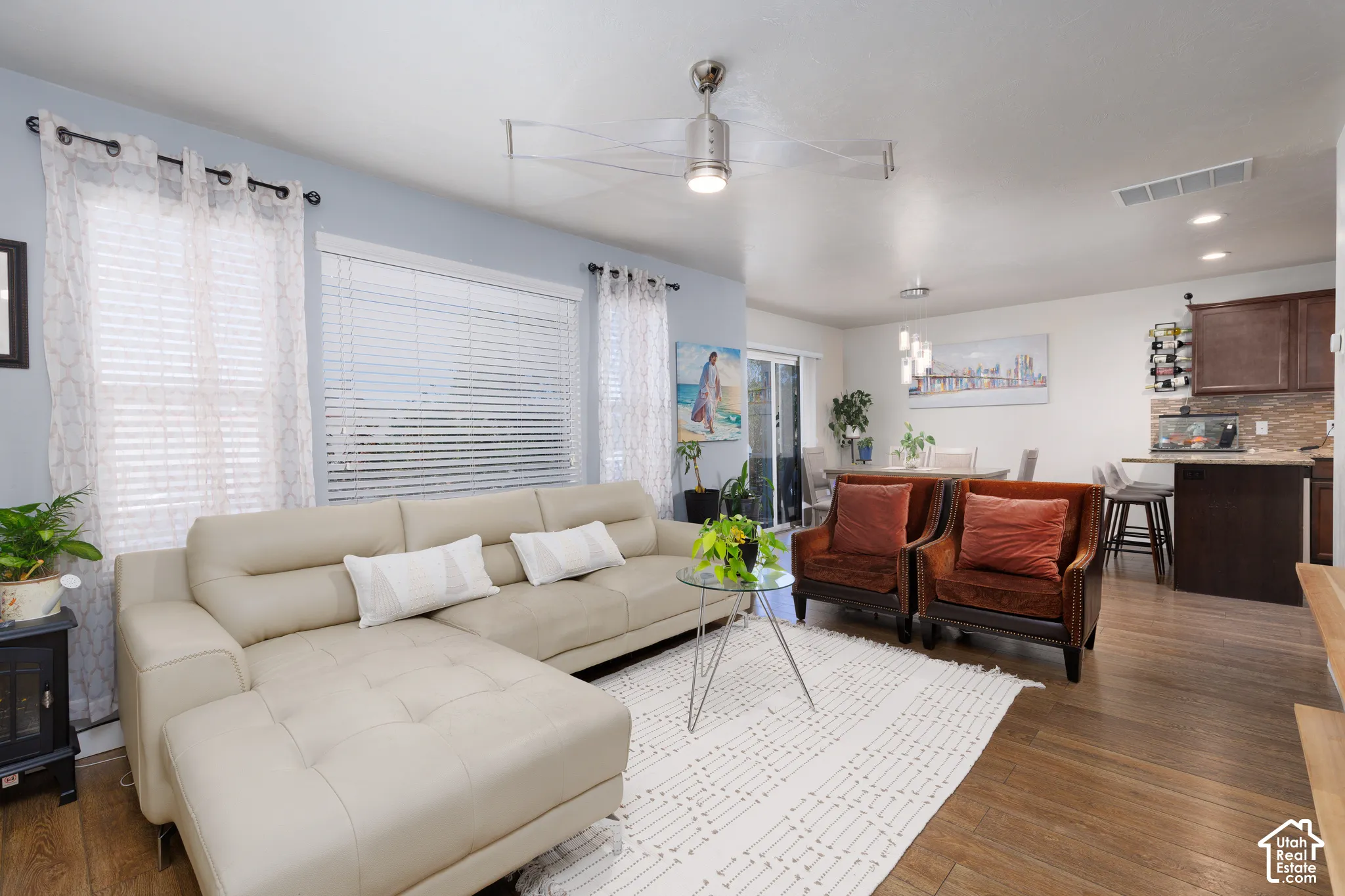 Spacious living area featuring wood-finish flooring, recessed lighting, and a modern ceiling fan
