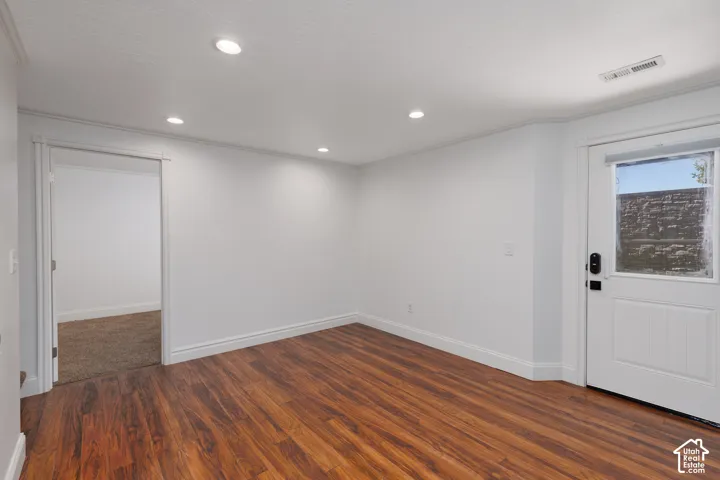 Wood-finish flooring, recessed lighting, and white trim accents