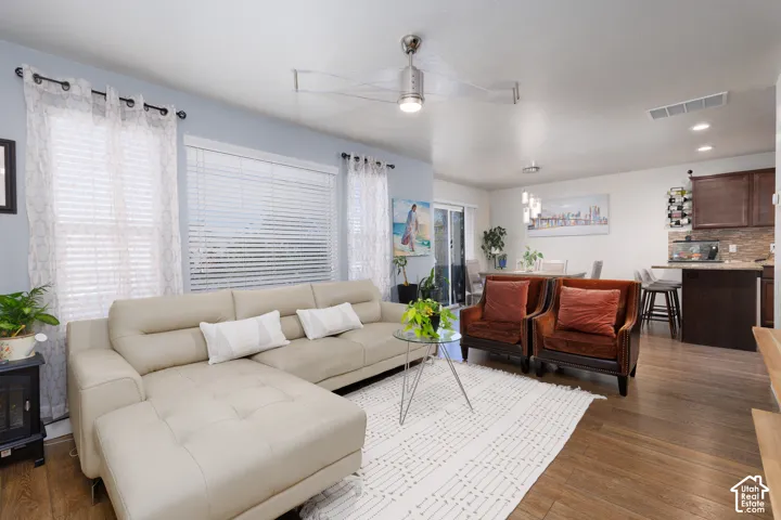 Spacious living area featuring wood-finish flooring, recessed lighting, and a modern ceiling fan