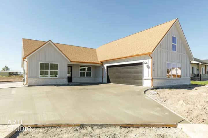 Light gray board-and-batten siding with white trim accents
