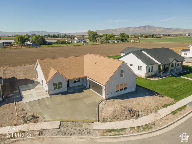 Newly constructed residence with board and batten siding, an attached two-car garage, and a concrete driveway