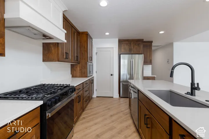 Kitchen featuring wood-finish flooring, recessed lighting, and white countertops