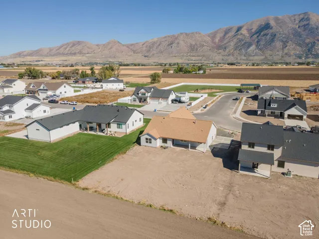 Newly constructed residence with a spacious lot, covered patio, and a two-car garage, set within a developing community with mountain backdrops