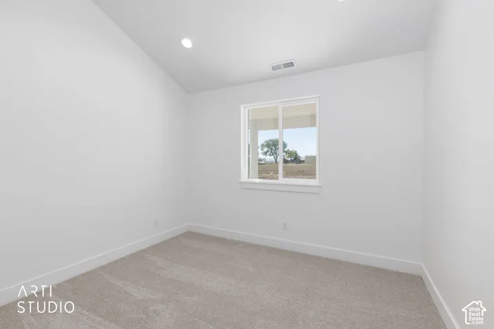 Southwest bedroom featuring a large window, recessed lighting, and light-toned carpeting.