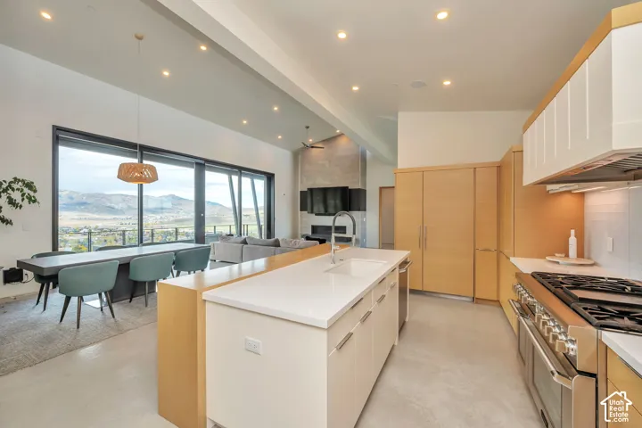 Kitchen with white countertops, wood-finish cabinetry, and stainless steel appliances