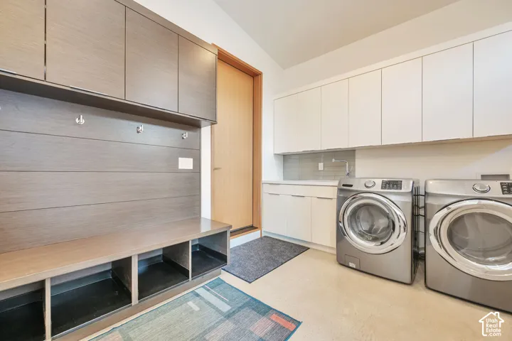 Built-in mudroom bench with storage cubbies and upper cabinetry