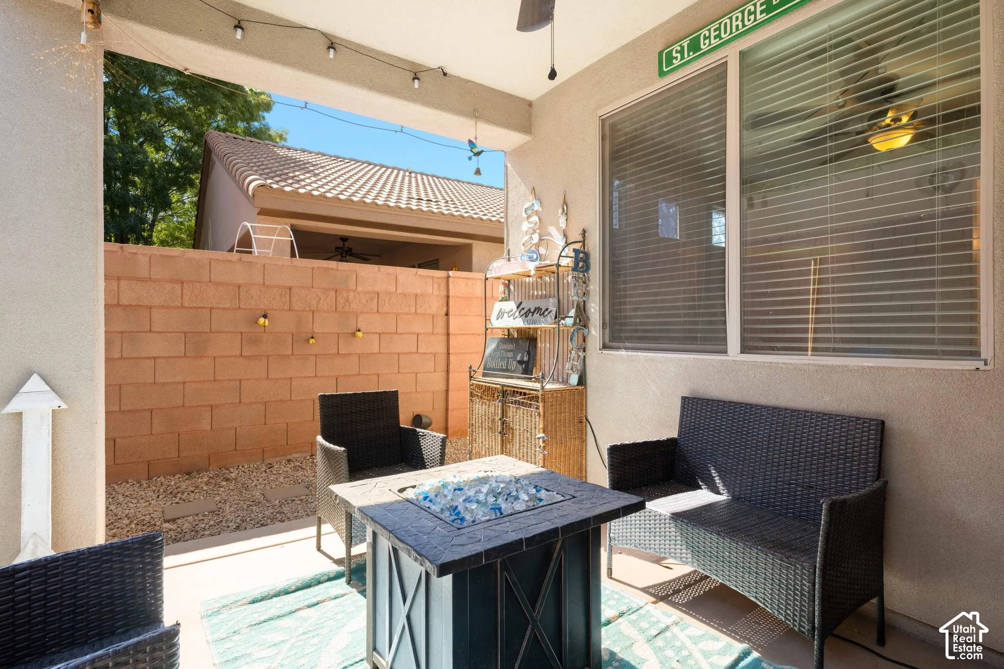 Covered patio with string lighting and ceiling fan