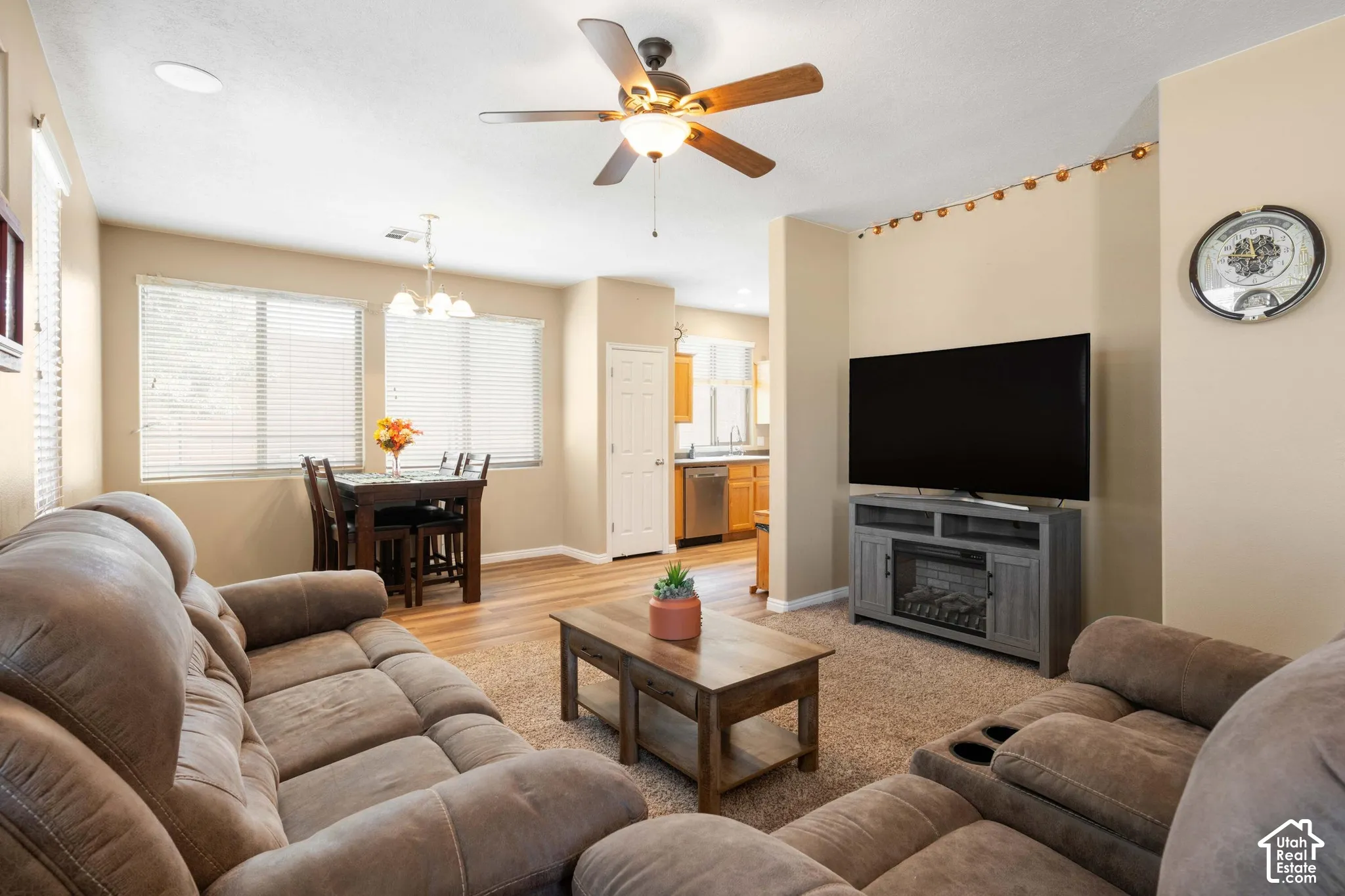 Spacious living area featuring a ceiling fan with integrated lighting, recessed lighting, and wood-finish flooring