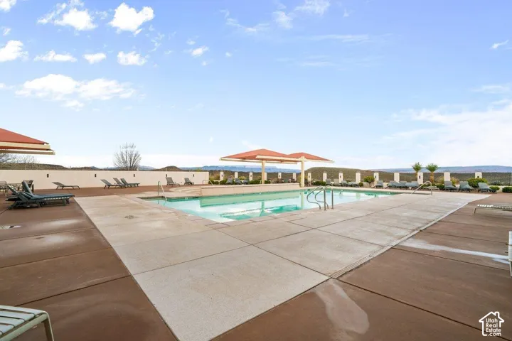 Expansive outdoor pool area with integrated spa