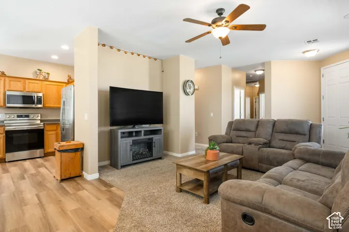 Kitchen featuring wood cabinetry, stainless steel appliances, and wood-finish flooring