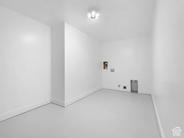 Utility space with light gray flooring and a flush-mount ceiling light