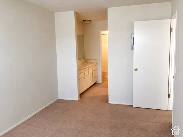 Living area looking toward the hall and bathroom vanity
