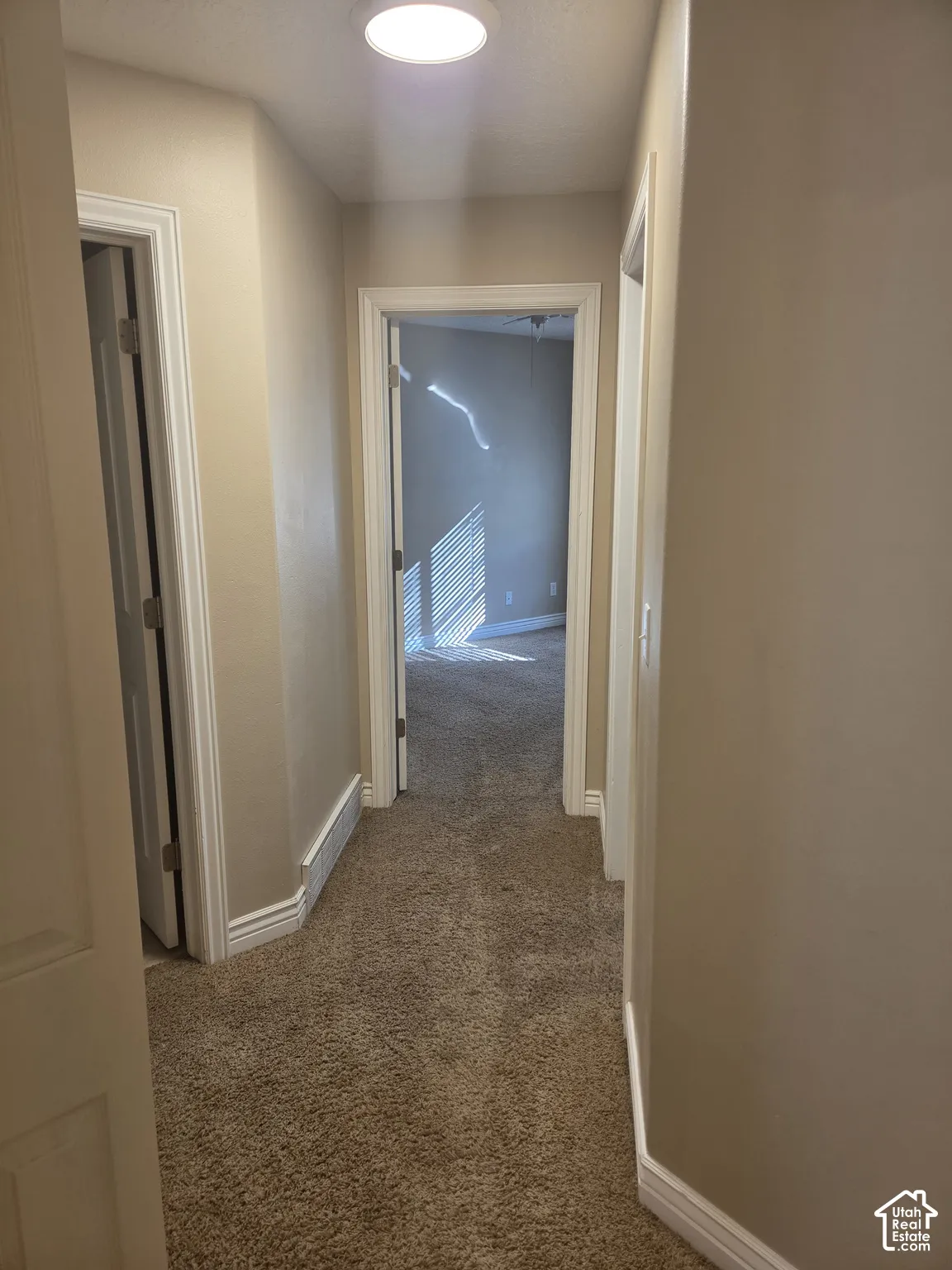 Recessed ceiling lighting, neutral wall palette, white trim, and carpeted flooring
